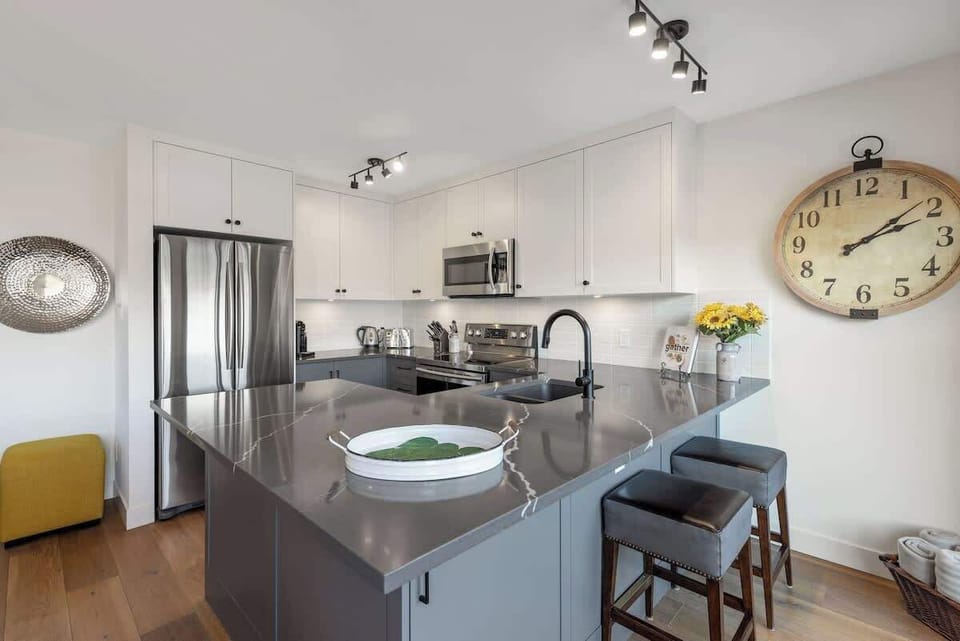- Sleek modern kitchen with stainless steel appliances and a large quartz island  
- Perfect for preparing meals or sipping coffee before a day on the slopes  
- Stylish lighting and cozy seating create a warm alpine dining experience  
