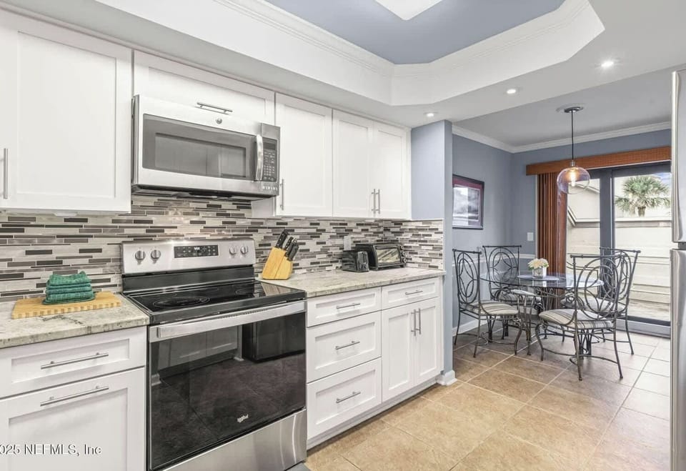 - Kitchen offers full appliances with white cabinets and chic details.  
- Cozy breakfast nook lets you enjoy casual meals in comfort.  
- Perfect for morning coffee or intimate dinners at home.  