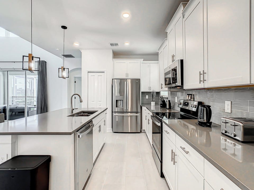 Bright modern kitchen with island and stainless steel appliances