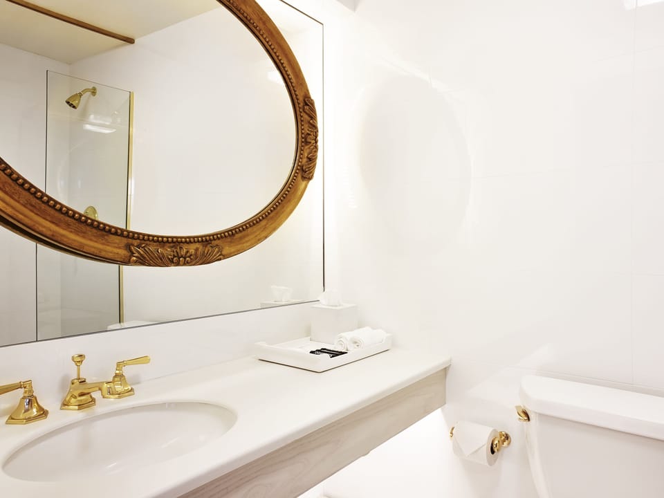 Refresh effortlessly at a bright vanity with elegant mirror.