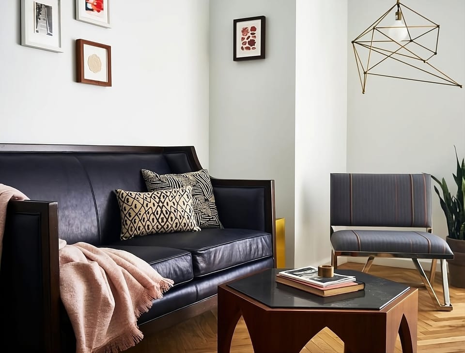 Unwind on the sleek sofa with warm, cozy vibes.