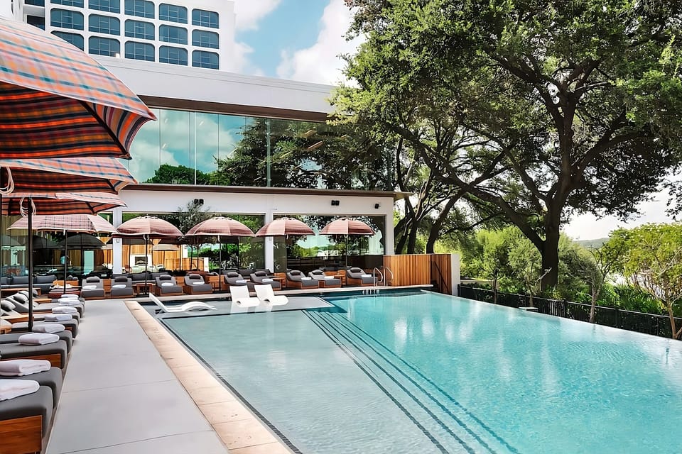 Dive into a sunlit poolside scene with luxe loungers.