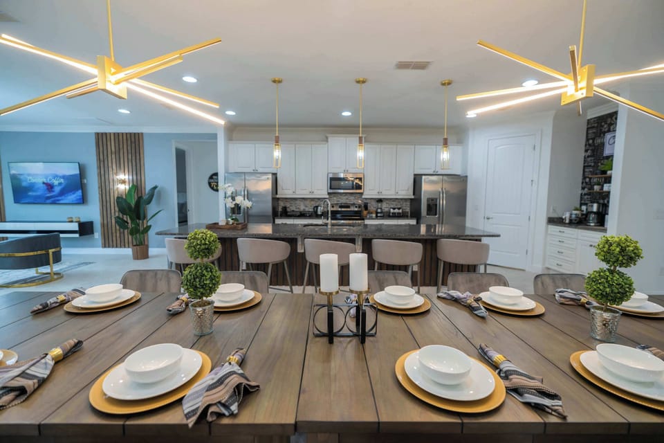 Elegant kitchen and dining area perfect for entertaining, featuring modern lighting and a spacious layout.