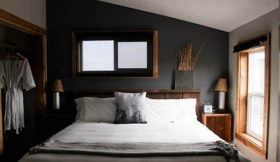 Drift off in a cozy bed framed by rustic-modern charm.