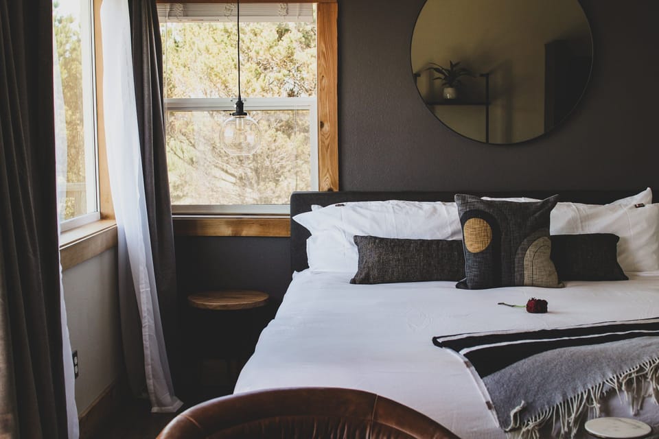 Stretch out in crisp bedding beside soothing natural light