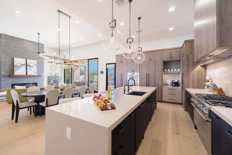 Chef-ready kitchen with massive island, gas range, and open flow to dining area