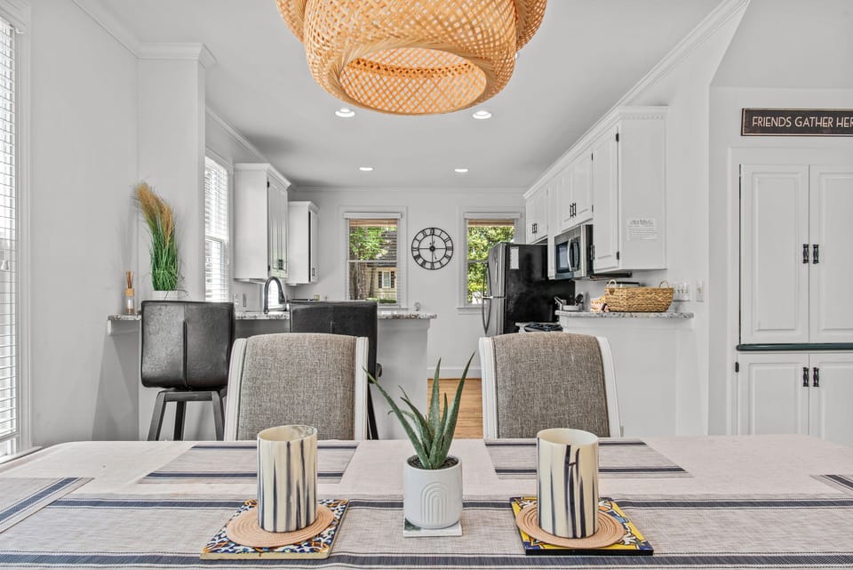 Dining table view with kitchen behind.