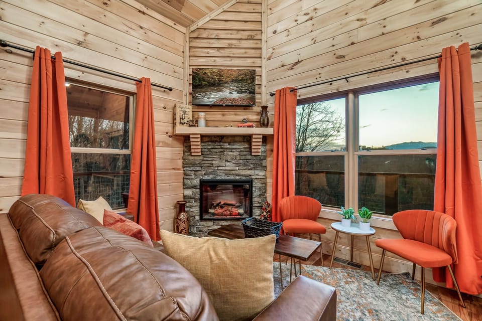 Warm cabin living in Sevierville, Tennessee! Enjoy a glowing fireplace, mountain views, cozy seating, and rustic charm—perfect for peaceful evenings in the Smokies. Book your getaway today!