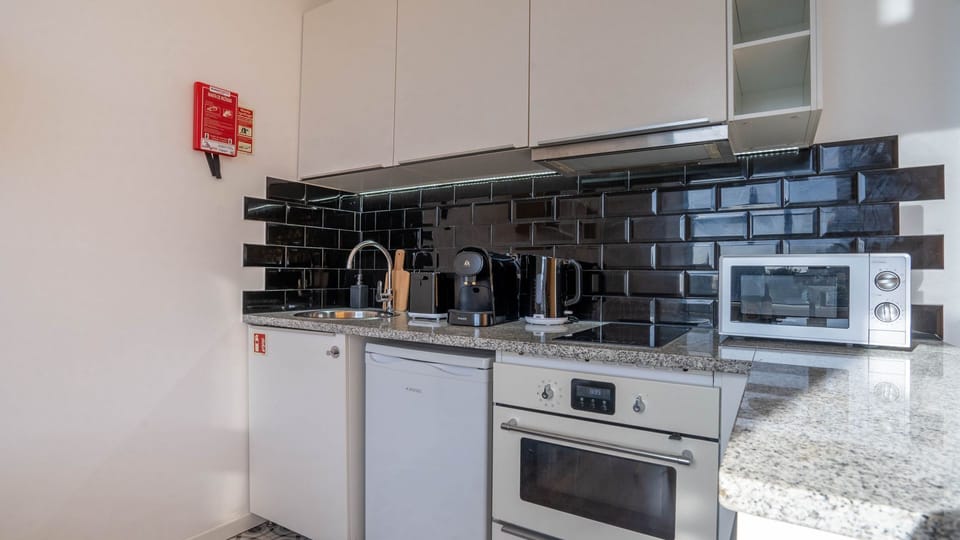 Explore your culinary skills in our compact yet well-equipped kitchenette, ideal for whipping up quick meals #practical #contemporary