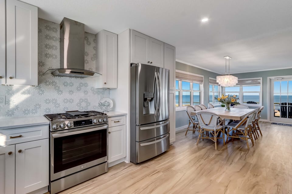The dining area opens to a magnificent gourmet kitchen ...
