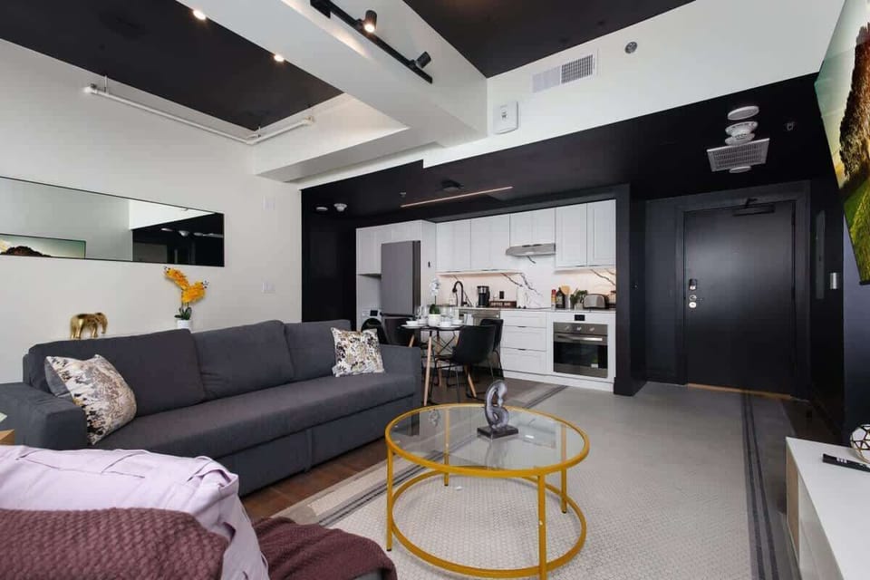 Living room with a sofa bed, TV, and open layout.