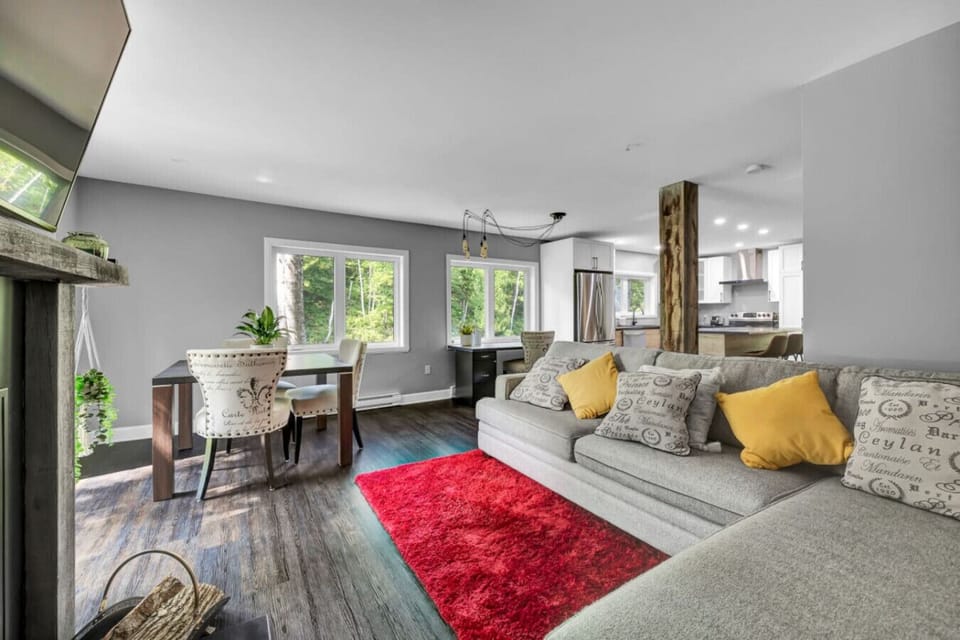 Open-concept living and dining area with garden views.
