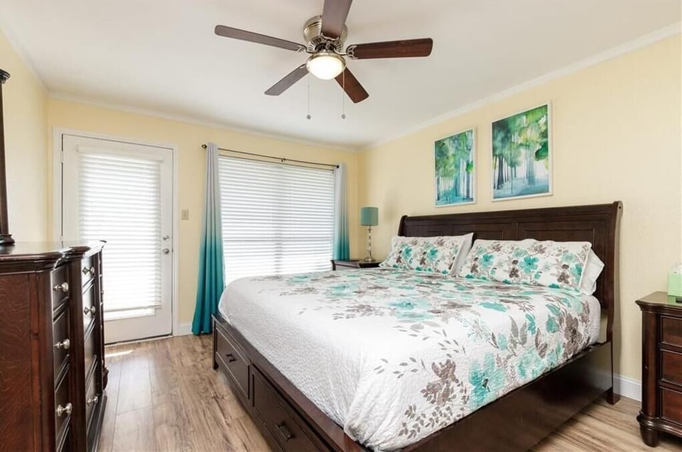 Drift off to sleep in your cozy bedroom with beautiful teal accents, peaceful artwork, and a private door to outdoor spaces.