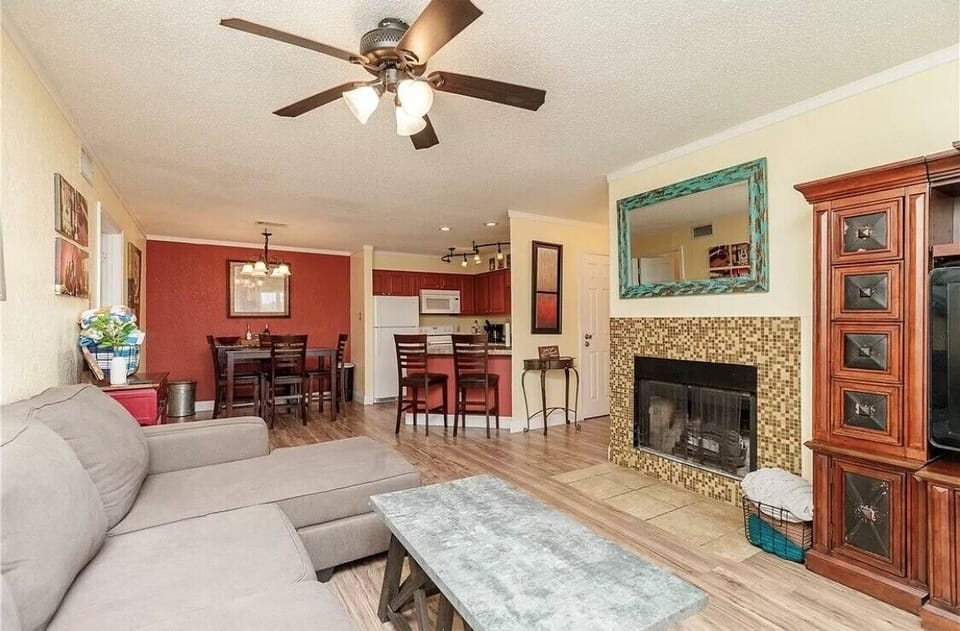 Unwind in your open-concept living space with cozy fireplace, modern kitchen, and thoughtful touches creating the perfect home-away-from-home atmosphere.