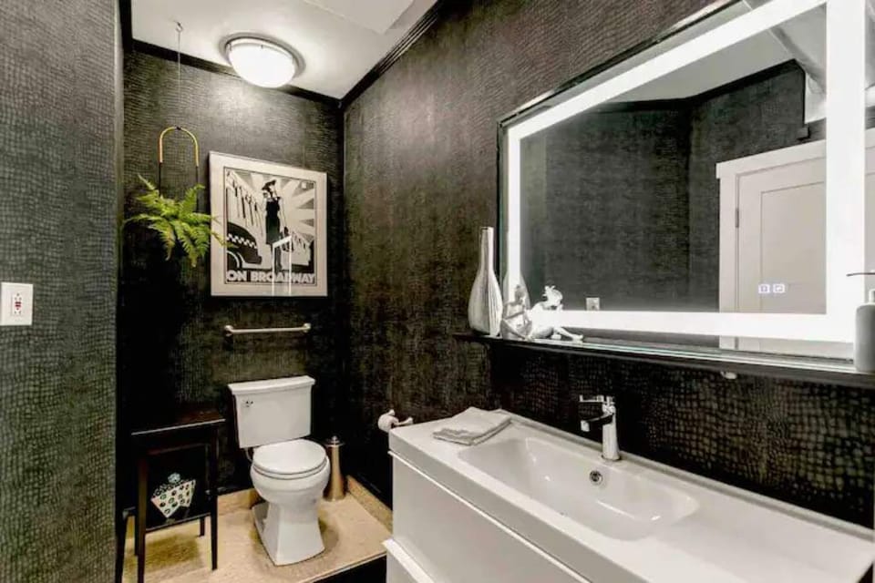 Black walls, lighted mirror and space for your stuff!