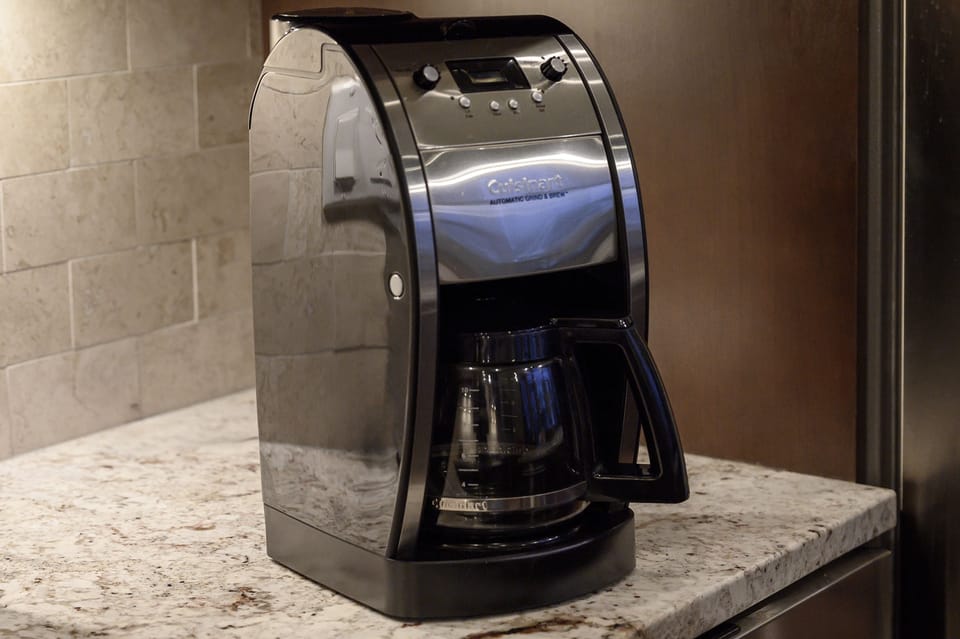 - Wake up with a fresh cup brewed from this sleek countertop coffee machine - Granite surfaces and backsplash give the space an upscale polished look - Simple style to kickstart mornings in the mountains with comfort