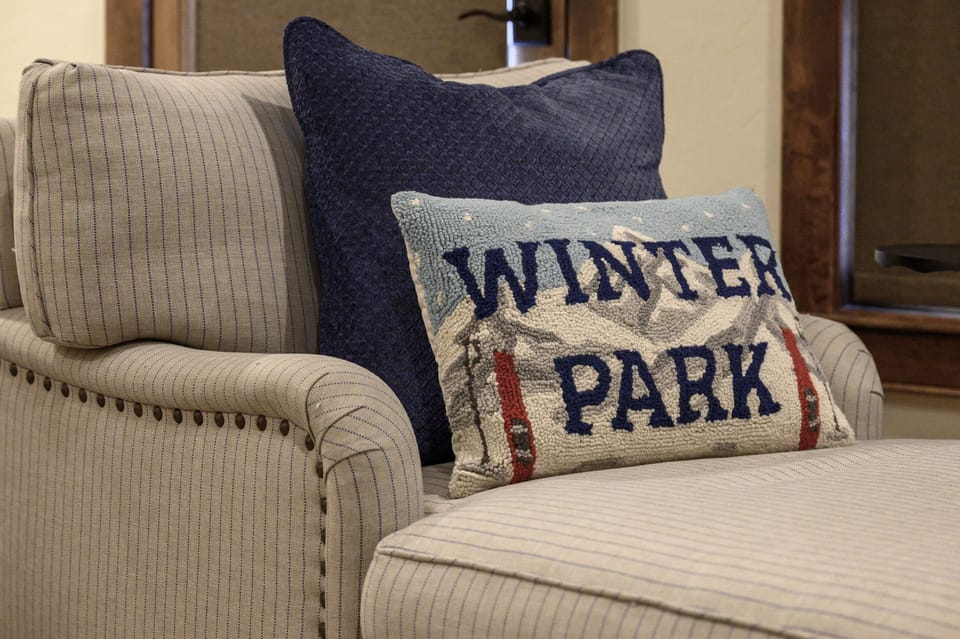 - Cozy up in this striped lounge chair accented with a textured Winter Park pillow - Soft blue tones and playful mountain embroidery bring regional charm indoors - Perfect reading nook or morning coffee spot in your alpine retreat