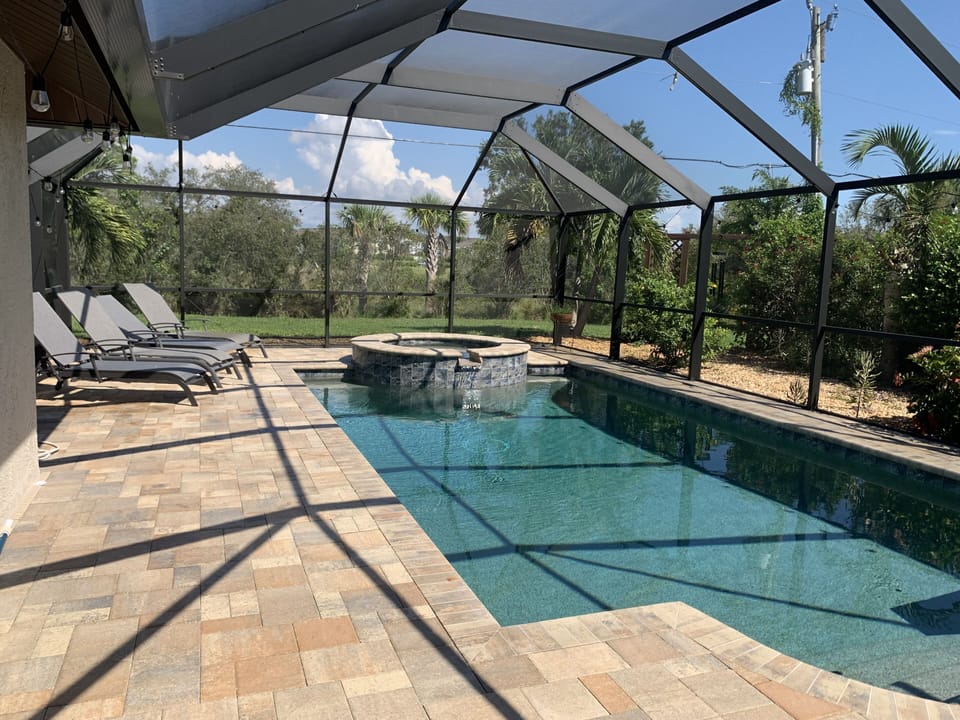 Enjoy year round swimming in fully enclosed pool and hot tub w/ 4 lounge chairs