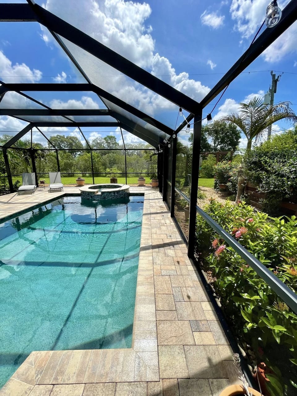 Newer brick paver patio surrounds pool