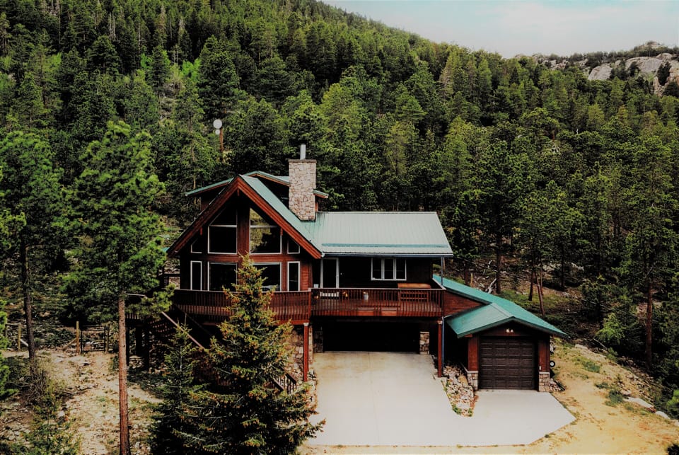 Custom mountain home on 7 private acres backing National Forest