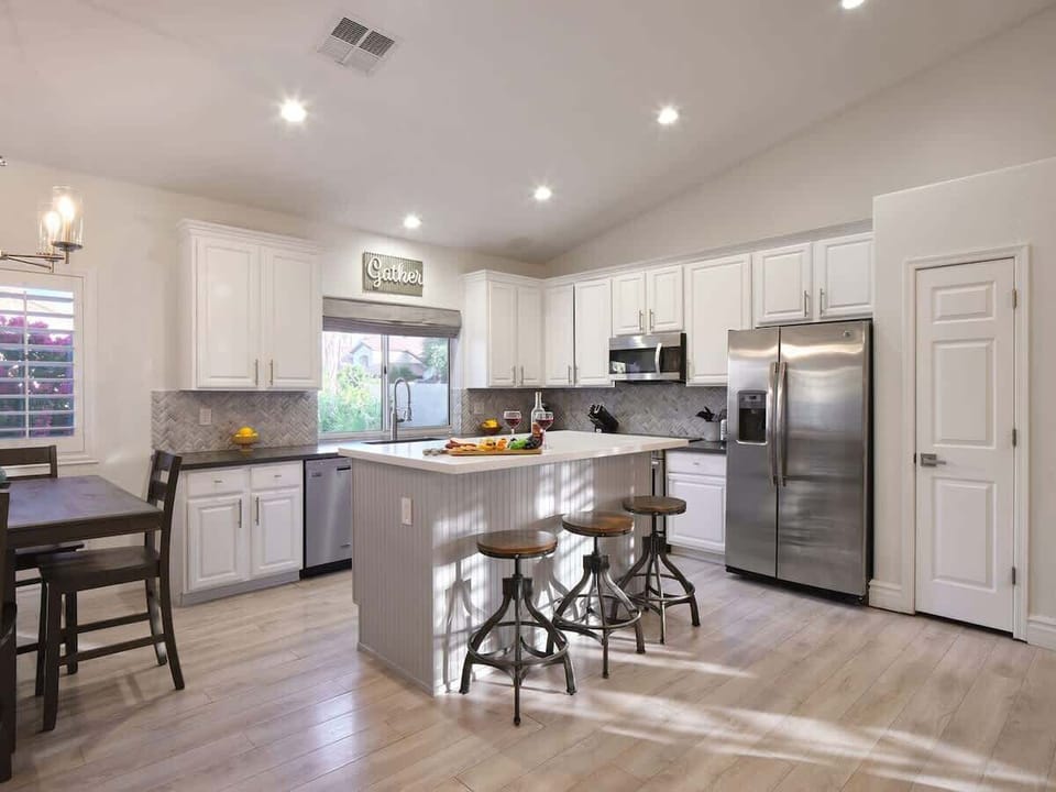 Open concept kitchen with stainless steel appliances, breakfast bar island seating, tons of natural light, and fully stocked with your basic cooking essentials.