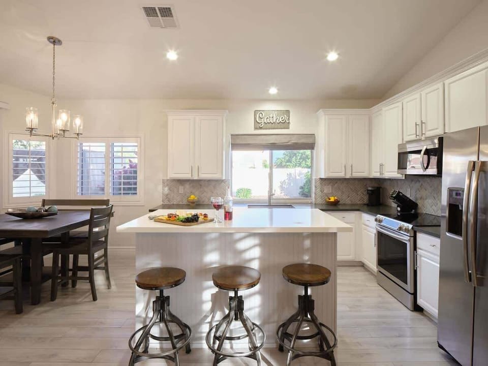 Open concept kitchen with stainless steel appliances, breakfast bar island seating, tons of natural light, and fully stocked with your basic cooking essentials.