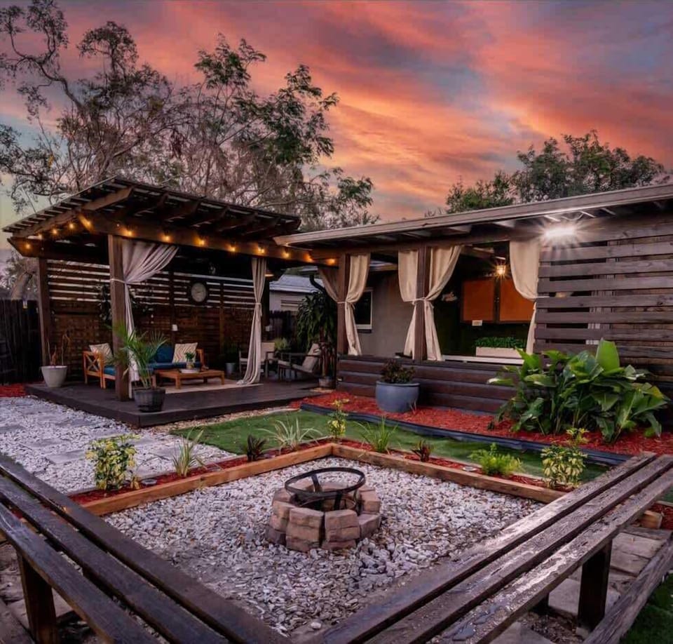 Outdoor living space. Equipped with outdoor smart TV, outdoor dining table & chairs, lounge area, firepit, outdoor grill & more