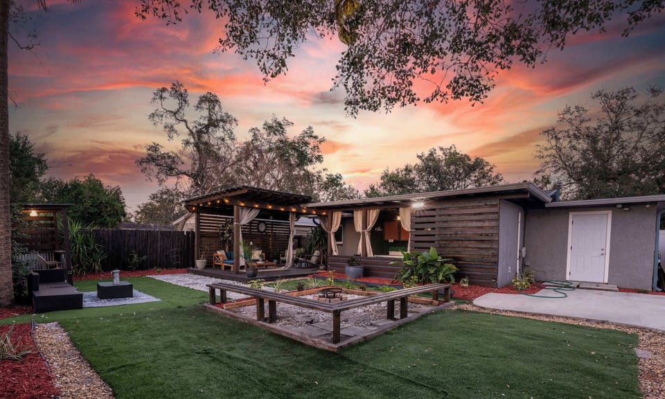 Outdoor living space. Equipped with outdoor smart TV, outdoor dining table & chairs, lounge area, firepit, outdoor grill & more