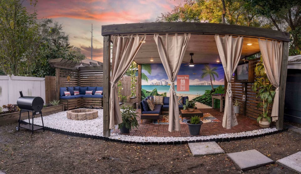 Outdoor living space full with seating, fire pit, Grill, Smart TV, etc.