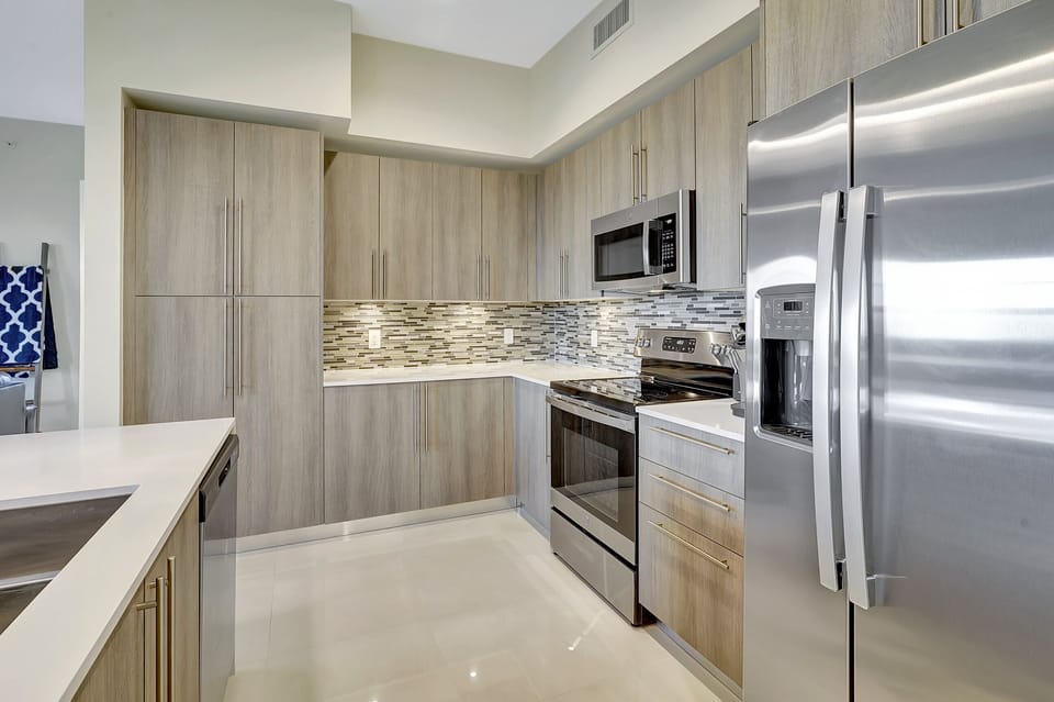 The kitchen is adorned with natural light and is fully equipped for seasonal rentals