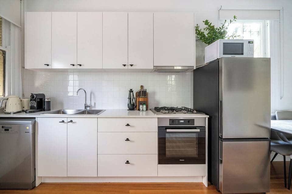 You’ll find all you need in the modern, streamlined kitchen to cook meals at home, with a door offering direct access to the outdoor dining area. 