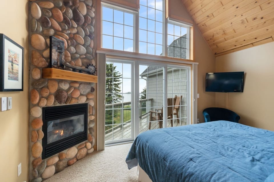Main Bedroom, with private patio, lake views, and a gas operated fireplace. 