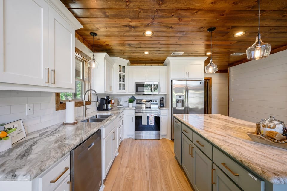 Sleek modern kitchen with marble countertop and spacious island.