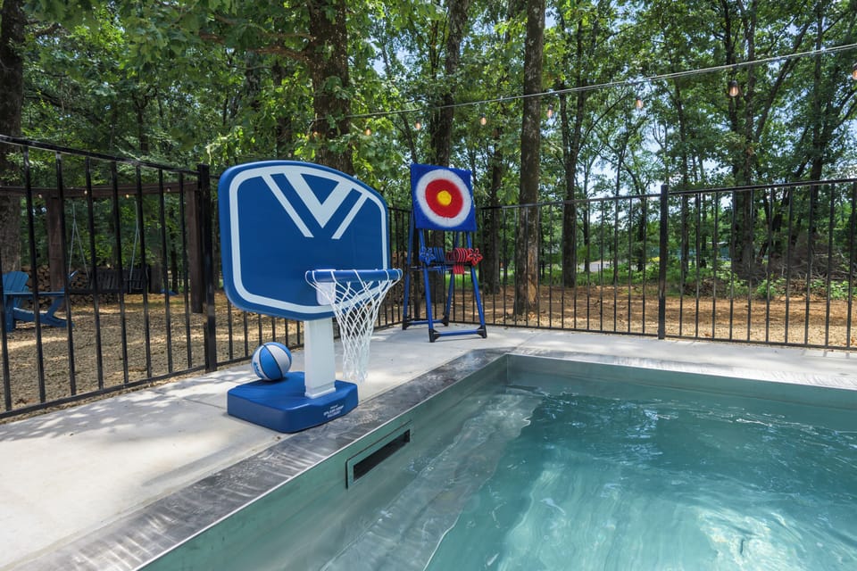 Backyard poolside games with a basketball hoop and colorful target in Broken Bow