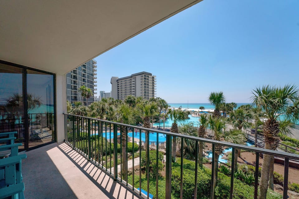 Relax on Adirondack chairs on the wraparound balcony enjoying  the panoramic view of the Gulf of Mexico and popular Edgewater Resort amenities-the Lagoon Pool and splash pad.