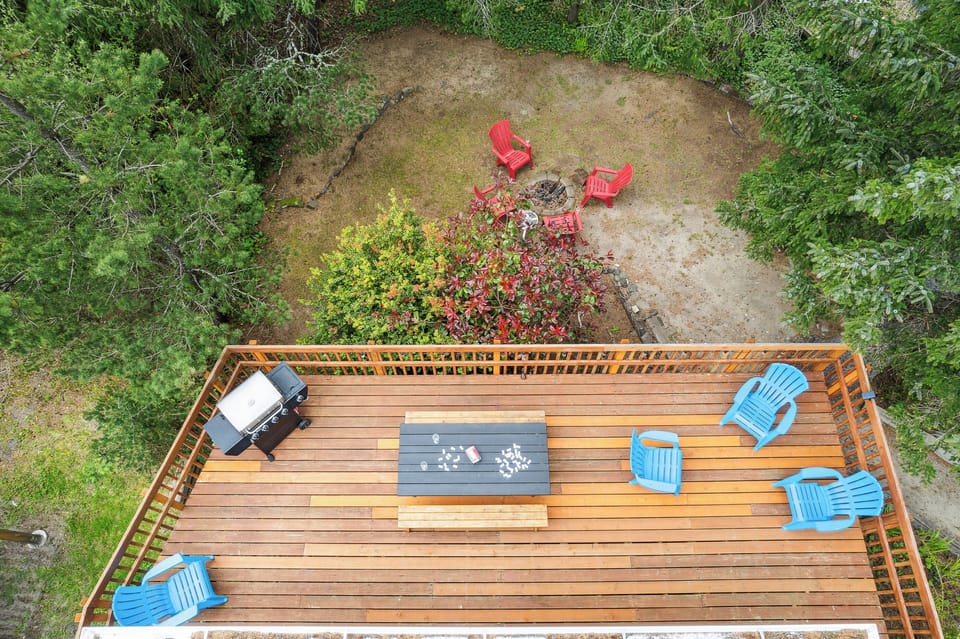 Back deck with picnic table. Perfect for puzzles, dominos etc. Adirondack chairs for lounging and gas BBQ for outdoor grilling.