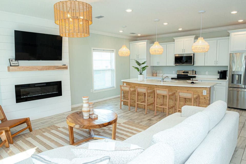 Gather around the fireplace and enjoy movie nights in this inviting living room. Plenty of space for family and friends to relax and connect.