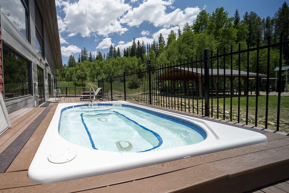 - Soak under the open sky in this serene outdoor hot tub surrounded by forest views - Relax your muscles after a long hike or ski day while enjoying fresh mountain air - Fenced for privacy with nearby seating and tranquil natural surroundings