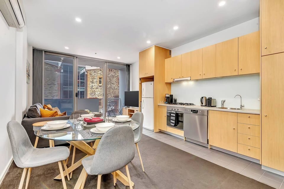 The apartment features an open-plan kitchen, dining and living area.