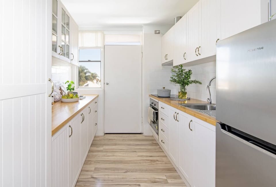 The bright and spacious kitchen leads to the balcony and is equipped with plenty of appliances and utensils for your stay