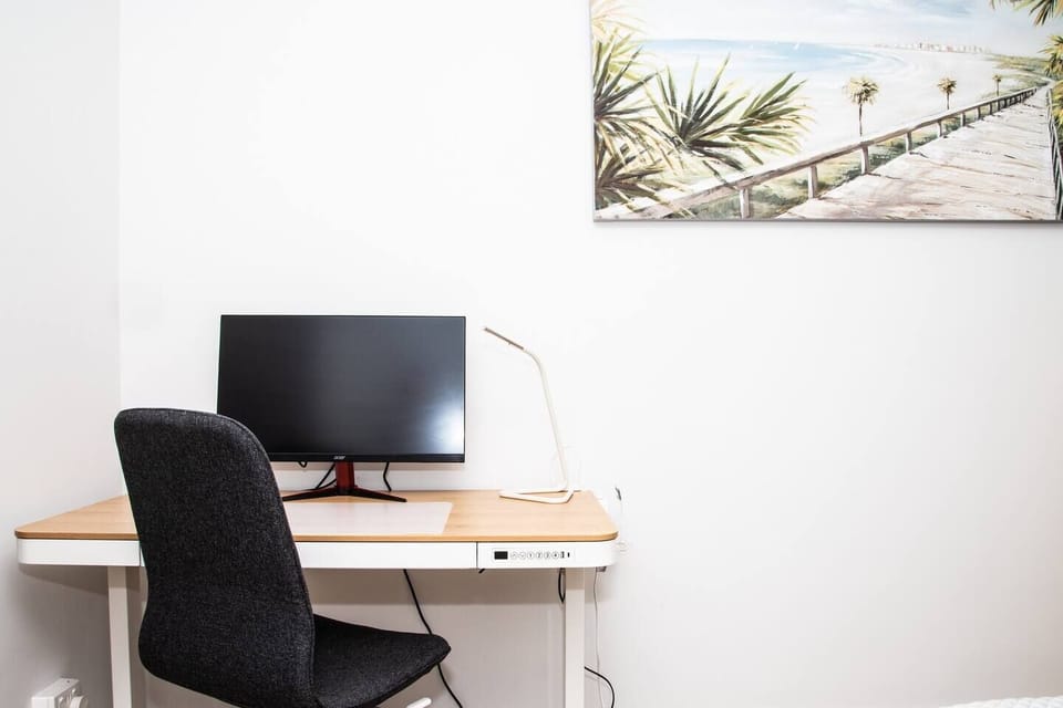 A study nook within the master bedroom makes it easy for those needing to catch up on business with a stand-up, sit-down desk.
