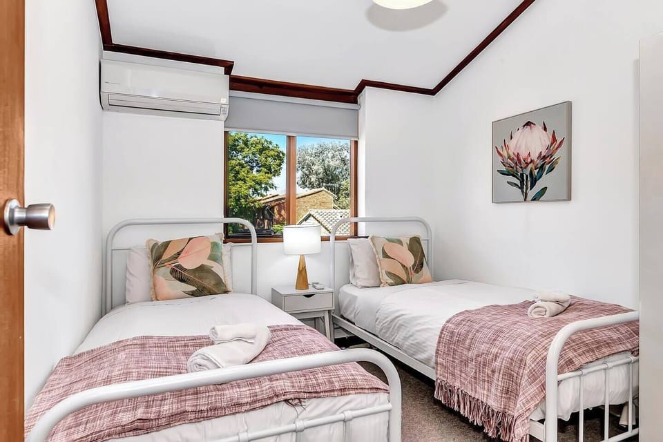 Perfect for travelling with kids, the second bedroom offers two plush single beds and ample storage space.