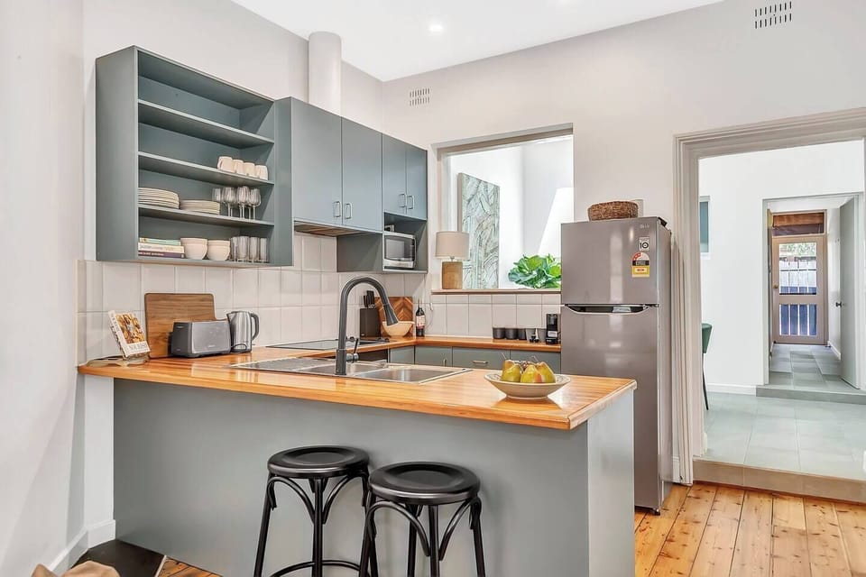 The kitchen is well equipped for meals at home with modern appliances and a breakfast bar.

