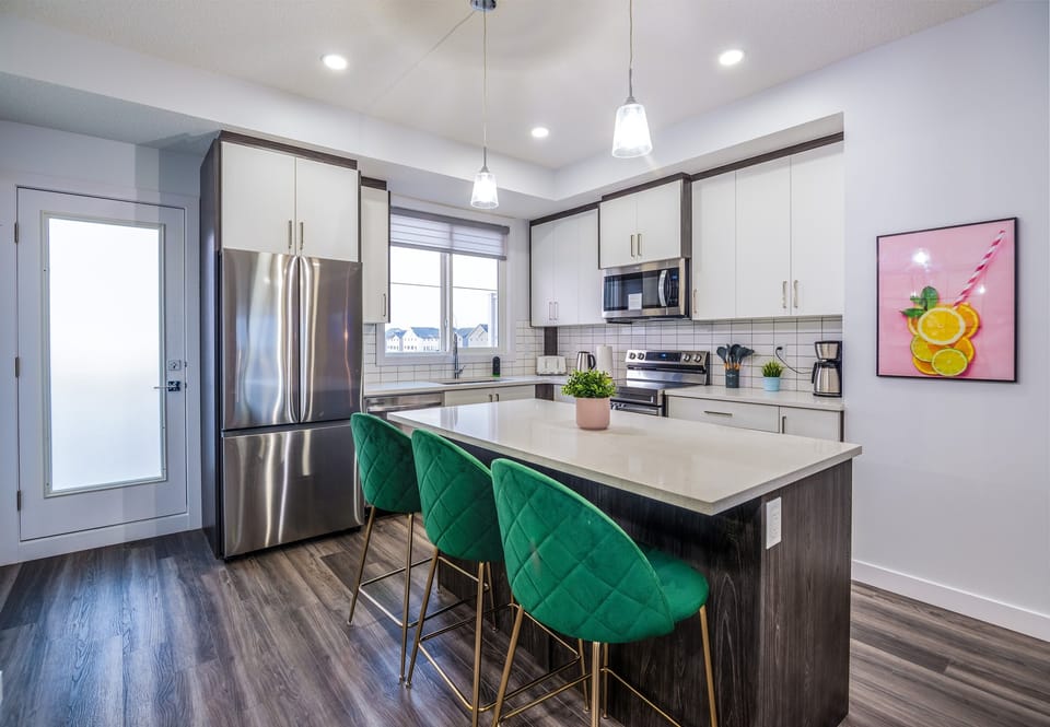 Enjoy meals together at the dining table or the convenient seating island in this stylish, functional kitchen space