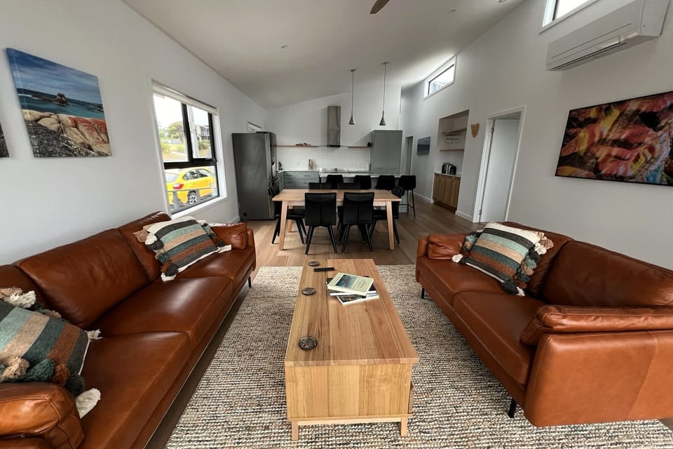 Leather lounges feature in the modern living area, which has sliding doors