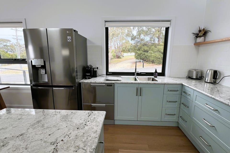Modern kitchen, large fridge freezer, dishwasher drawers, granite bench tops etc