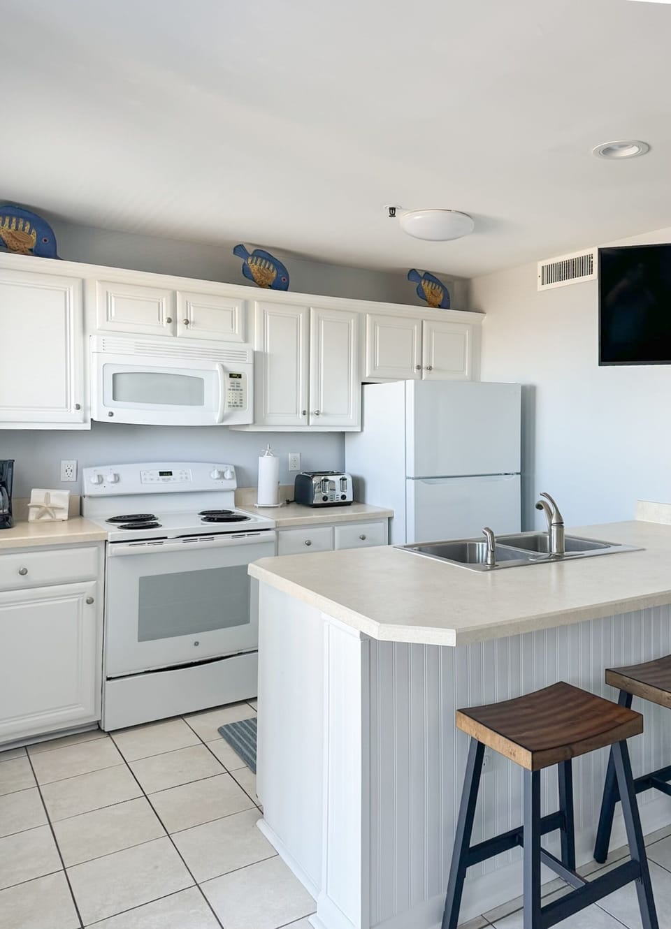 Kitchen with crock pot, coffee pot,  blender, toaster, cork screw and more! 