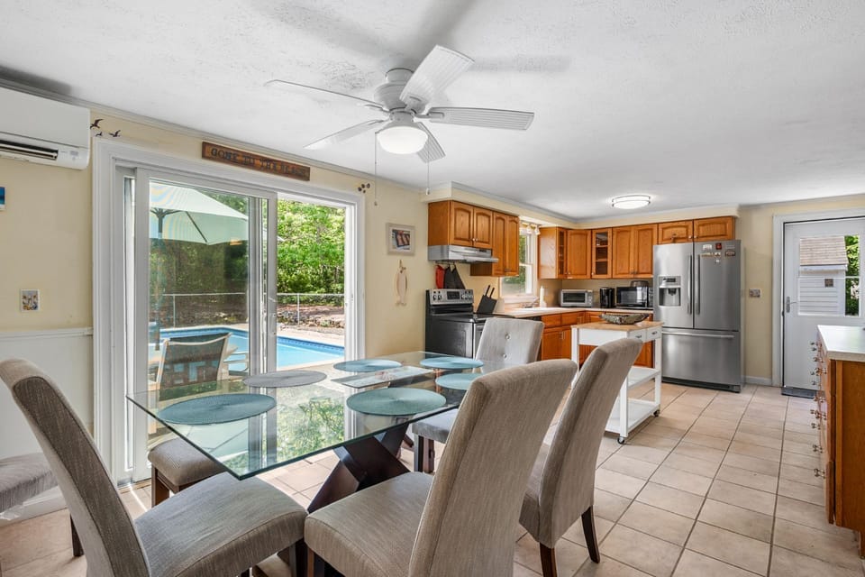 Dining area with a large slider that leads out into the backyard.