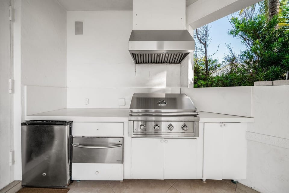Summer kitchen has easy access to the indoor area