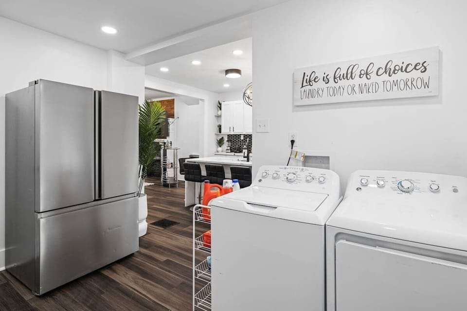 Durable washer and dryer with detergent and bleach already provided 
alongside a side by side refrigerator.
